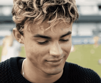 A Close Up Of A Man 'S Face With A Sweater On GIF