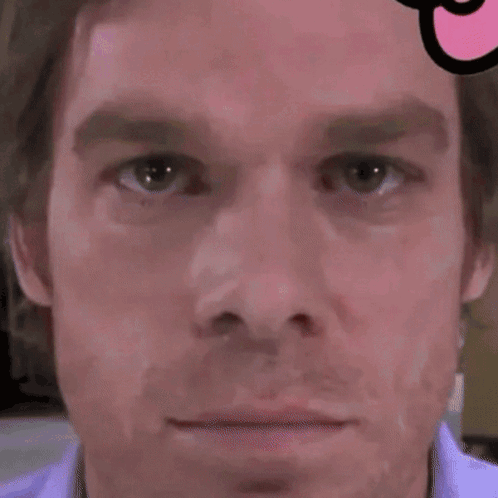 A Close Up Of A Man 'S Face With A Swiss Cross On It GIF