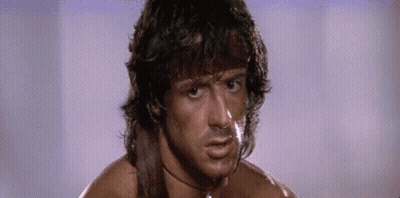 A Close Up Of A Man 'S Face With A Sword Around His Neck And A Choker . GIF