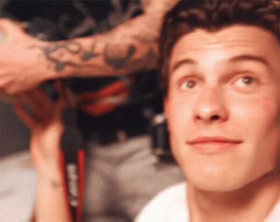 A Close Up Of A Man 'S Face With A Tattoo On His Arm That Says Casio GIF