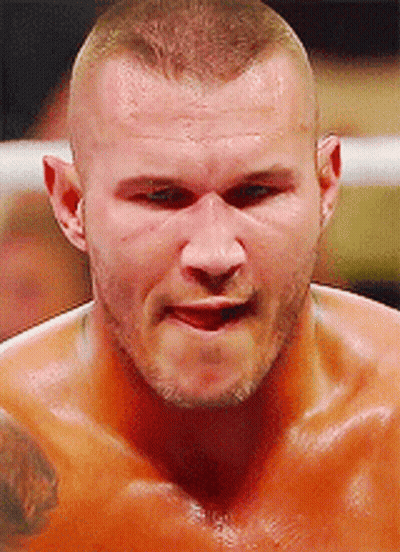 A Close Up Of A Man 'S Face With A Tattoo On His Chest GIF