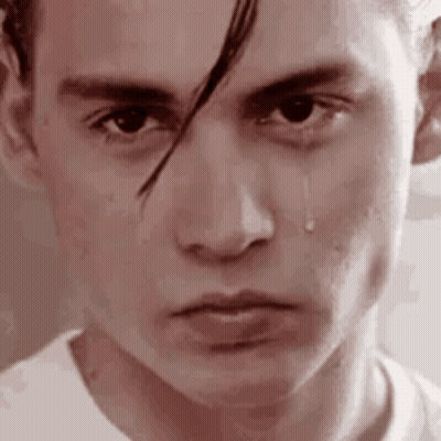 A Close Up Of A Man 'S Face With A Tear Coming Down His Cheek . GIF