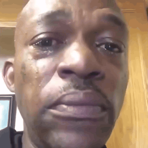 A Close Up Of A Man 'S Face With A Tear Coming Out Of His Eye . GIF