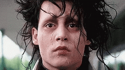 A Close Up Of A Man 'S Face With A Tear Coming Out Of His Nose . GIF