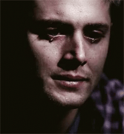 A Close Up Of A Man 'S Face With A Tear Running Down His Cheek GIF