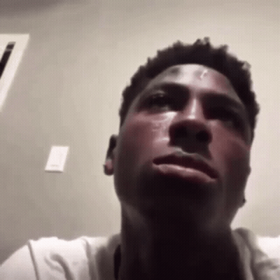 A Close Up Of A Man 'S Face With A Tear Running Down His Cheek . GIF