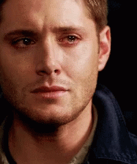 A Close Up Of A Man 'S Face With A Tear Running Down His Face . GIF