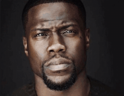 A Close Up Of A Man 'S Face With A Triangle In The Background GIF