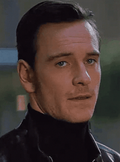 A Close Up Of A Man 'S Face With A Turtleneck And A Leather Jacket GIF