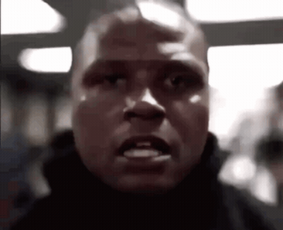 A Close Up Of A Man 'S Face With A Very Angry Expression . GIF