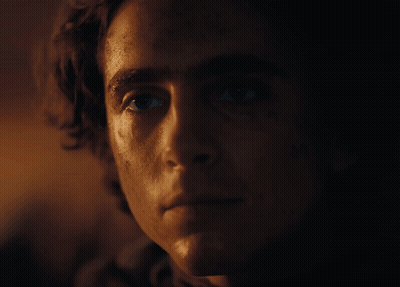 A Close Up Of A Man 'S Face With A Very Dark Background GIF