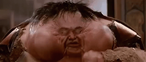 A Close Up Of A Man 'S Face With A Very Large Head And A Very Large Mouth . GIF