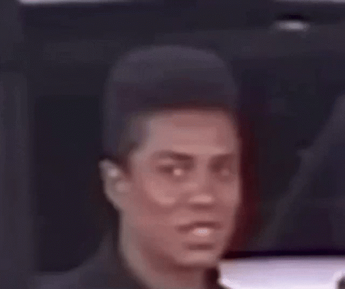 A Close Up Of A Man 'S Face With A Very Short Haircut . GIF