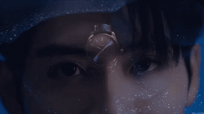 A Close Up Of A Man 'S Face With A Watch In The Foreground GIF