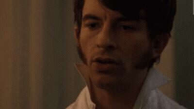 A Close Up Of A Man 'S Face With A White Collar GIF