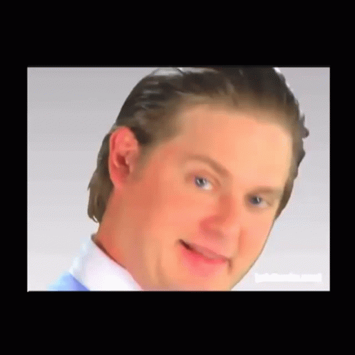 A Close Up Of A Man 'S Face With A White Shirt And Blue Shirt GIF