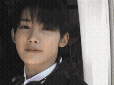 A Close Up Of A Man 'S Face With A White Shirt And Tie GIF