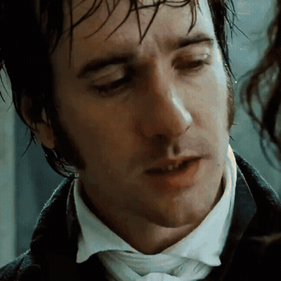A Close Up Of A Man 'S Face With A White Shirt And Tie GIF
