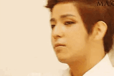 A Close Up Of A Man 'S Face With A White Shirt On And A Serious Look On His Face . GIF
