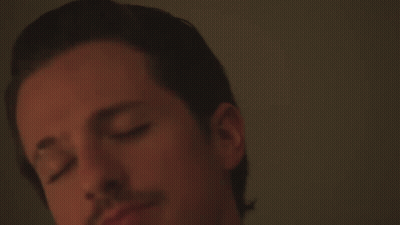 A Close Up Of A Man 'S Face With A White Shirt On GIF