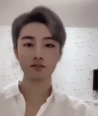 A Close Up Of A Man 'S Face With A White Shirt On . GIF