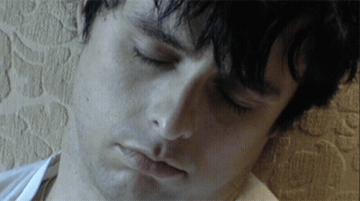 A Close Up Of A Man 'S Face With A White Shirt On GIF