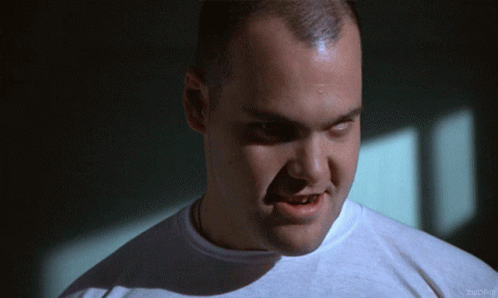 A Close Up Of A Man 'S Face With A White Shirt That Says Imdb On The Bottom Left GIF