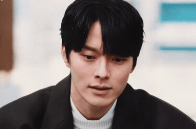 A Close Up Of A Man 'S Face With A White Sweater On GIF