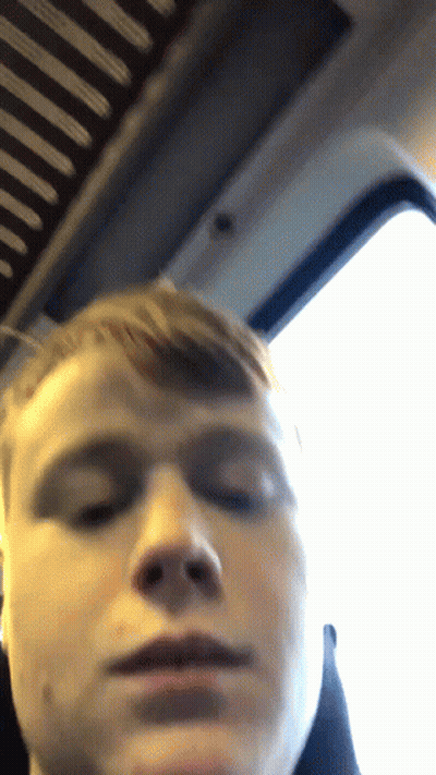 A Close Up Of A Man 'S Face With A Window In The Background GIF