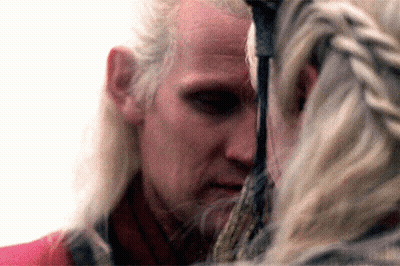 A Close Up Of A Man 'S Face With A Woman Behind Him GIF