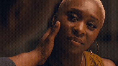 A Close Up Of A Man 'S Face With A Woman In The Background GIF