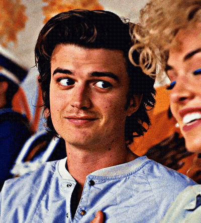 A Close Up Of A Man 'S Face With A Woman In The Background GIF