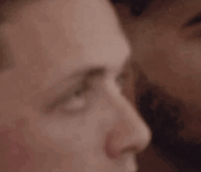 A Close Up Of A Man 'S Face With A Woman 'S Face Behind Him . GIF