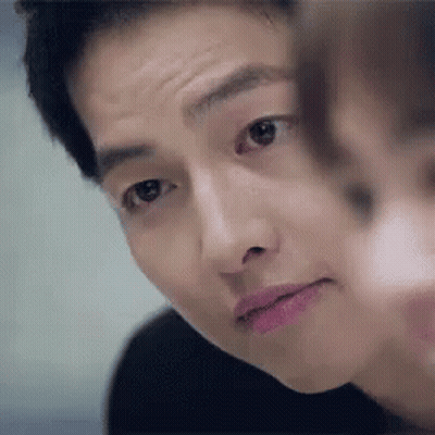 A Close Up Of A Man 'S Face With A Woman 'S Face Behind Him . GIF