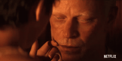 A Close Up Of A Man 'S Face With A Woman 'S Hand Touching It . GIF