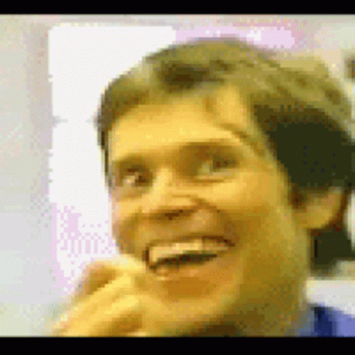 A Close Up Of A Man 'S Face With A Yellow Background GIF