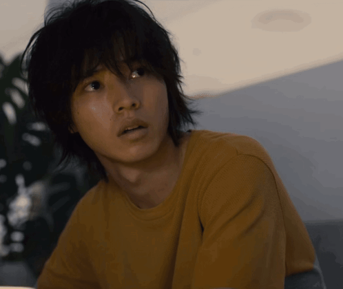 A Close Up Of A Man 'S Face With A Yellow Shirt GIF