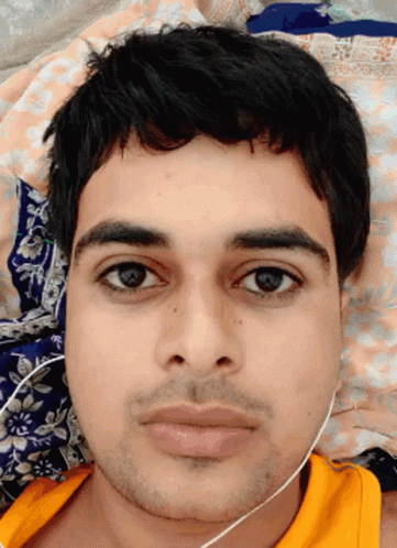 A Close Up Of A Man 'S Face With A Yellow Shirt GIF