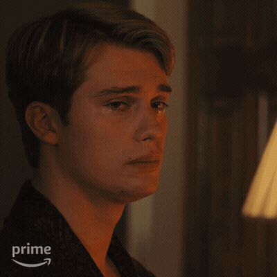 A Close Up Of A Man 'S Face With An Amazon Prime Logo In The Background GIF