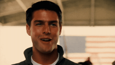 A Close Up Of A Man 'S Face With An American Flag Behind Him GIF