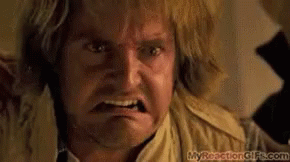 A Close Up Of A Man 'S Face With An Angry Look On His Face . GIF