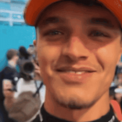 A Close Up Of A Man 'S Face With An Orange Hat On GIF