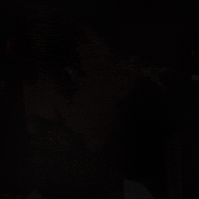 A Close Up Of A Man 'S Face With An X On The Back Of A Chair GIF