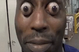 A Close Up Of A Man 'S Face With Big Eyes . GIF