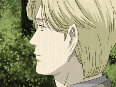 A Close Up Of A Man 'S Face With Blonde Hair And A Green Background GIF