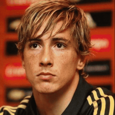 A Close Up Of A Man 'S Face With Blonde Hair And Freckles Wearing A Black And Yellow Adidas Shirt . GIF