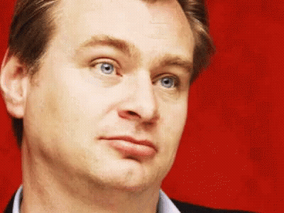 A Close Up Of A Man 'S Face With Blue Eyes Against A Red Background GIF