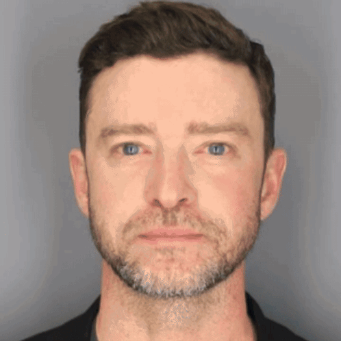 A Close Up Of A Man 'S Face With Blue Eyes And A Beard GIF