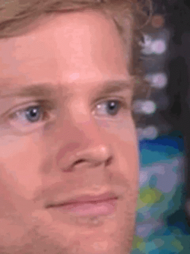 A Close Up Of A Man 'S Face With Blue Eyes And A Beard GIF