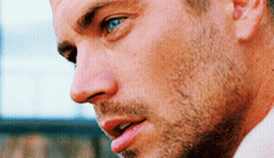 A Close Up Of A Man 'S Face With Blue Eyes And A Beard GIF